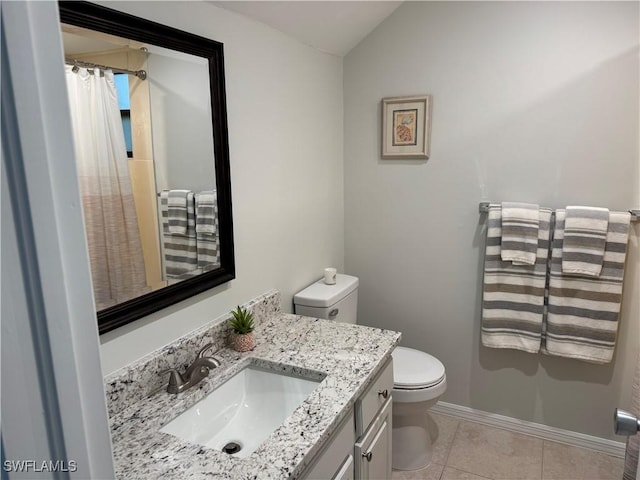 1281 Solana Rd, Naples, FL 34103 - full bathroom with toilet, tile patterned flooring, baseboards, vanity, and vaulted ceiling