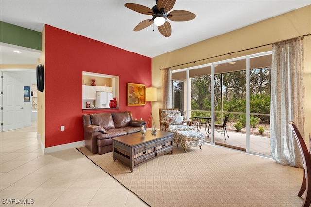 tiled living room with baseboards and a ceiling fan