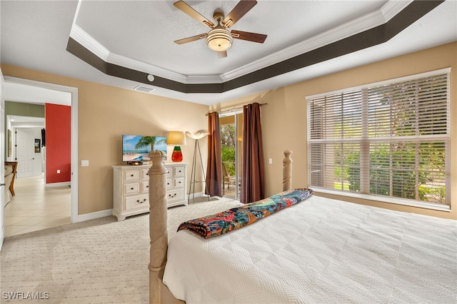 bedroom with access to outside, a tray ceiling, crown molding, light tile patterned floors, and baseboards