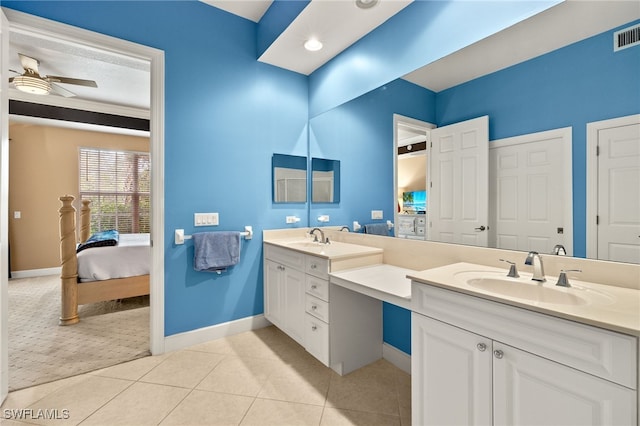 full bath with a sink, double vanity, ceiling fan, and tile patterned floors