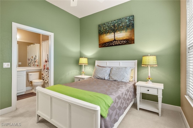 bedroom with carpet, baseboards, and ensuite bathroom