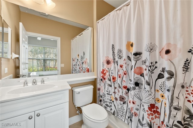 bathroom featuring toilet, vanity, and a shower with shower curtain