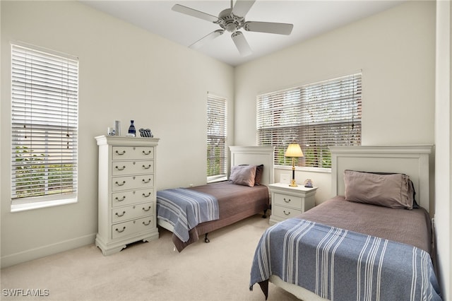 bedroom with baseboards, light colored carpet, and ceiling fan