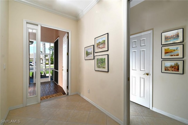 foyer featuring light tile patterned flooring, baseboards, and ornamental molding