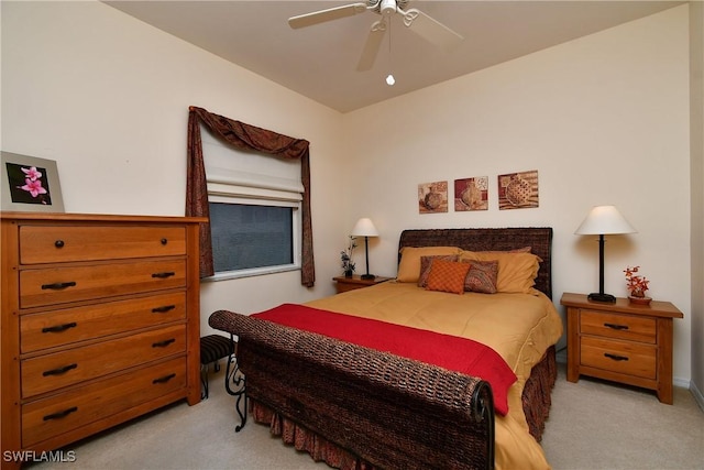 bedroom with light colored carpet and a ceiling fan