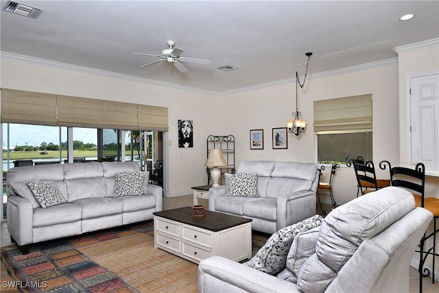 living area with recessed lighting, visible vents, ornamental molding, and ceiling fan with notable chandelier