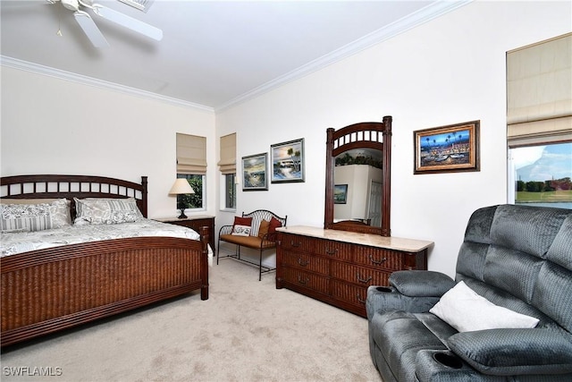 carpeted bedroom with ornamental molding and a ceiling fan