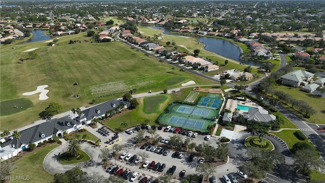 birds eye view of property with view of golf course, a water view, and a residential view