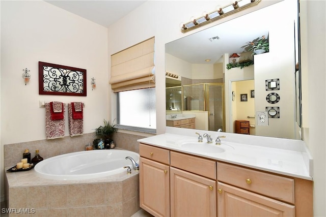 bathroom with a bath, visible vents, a shower stall, and vanity