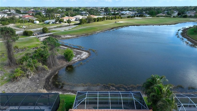 drone / aerial view with view of golf course and a water view