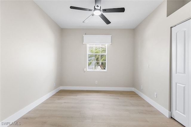 unfurnished room featuring baseboards, ceiling fan, and light wood finished floors