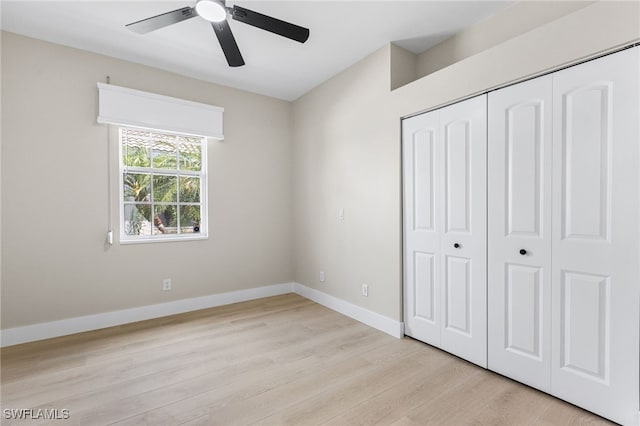 unfurnished bedroom with a closet, baseboards, ceiling fan, and light wood-type flooring