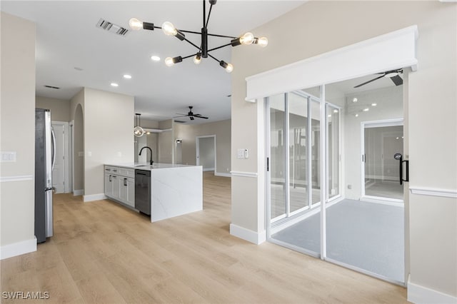 kitchen featuring freestanding refrigerator, visible vents, ceiling fan with notable chandelier, and dishwasher