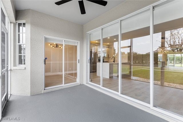 unfurnished sunroom featuring a sink and a notable chandelier