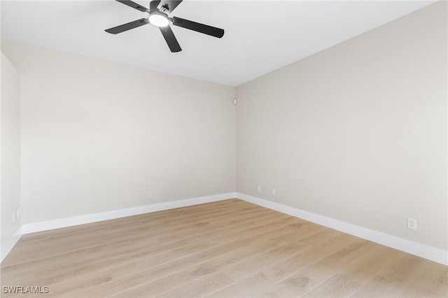 spare room featuring baseboards, ceiling fan, and light wood-type flooring