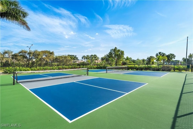 view of tennis court featuring fence and community basketball court