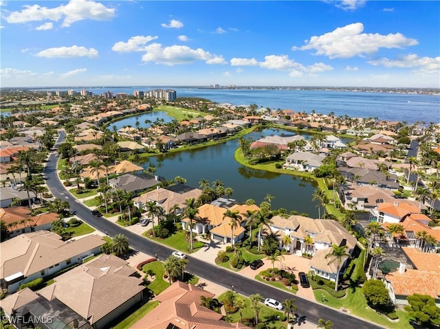 drone / aerial view with a residential view and a water view