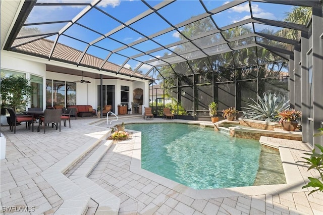 view of pool featuring a pool with connected hot tub, ceiling fan, glass enclosure, outdoor dining space, and a patio