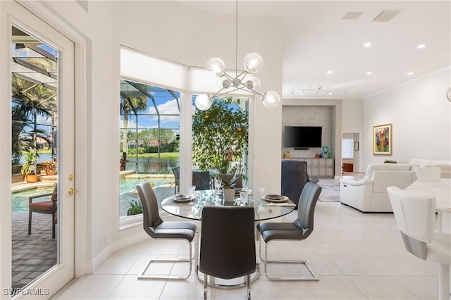 dining room with light tile patterned floors, recessed lighting, rail lighting, and an inviting chandelier