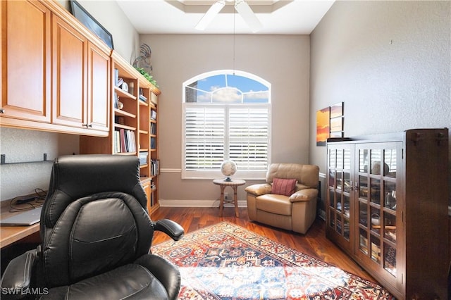 home office featuring baseboards, ceiling fan, and wood finished floors