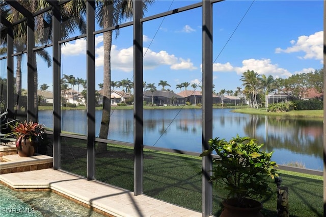 unfurnished sunroom with a water view