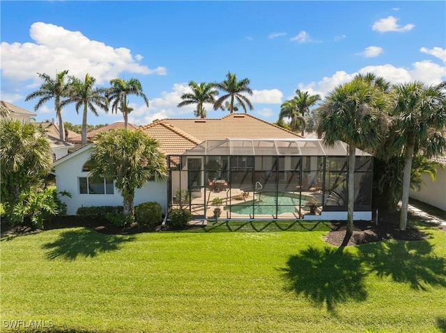 back of property featuring a fenced in pool, a lawn, a lanai, and a tile roof