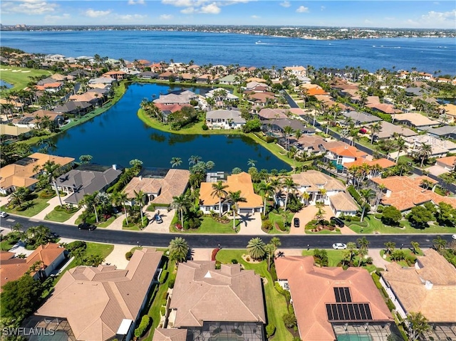 bird's eye view featuring a residential view and a water view