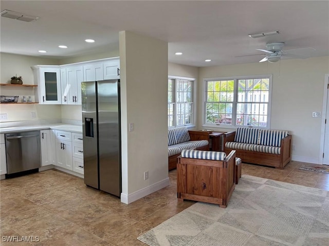 kitchen featuring visible vents, white cabinetry, stainless steel appliances, and light countertops