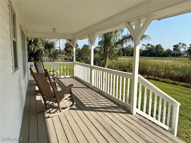 wooden terrace with a lawn