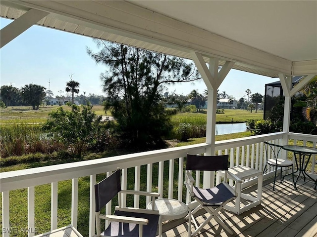 wooden deck featuring a water view