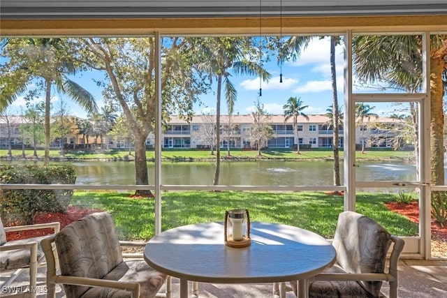 sunroom / solarium with a water view