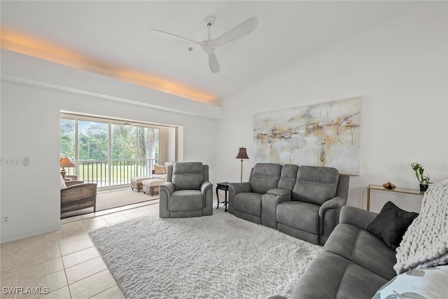 living room featuring tile patterned floors, a ceiling fan, and lofted ceiling