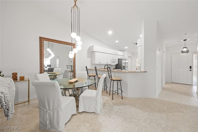 dining room with vaulted ceiling, light tile patterned floors, and recessed lighting