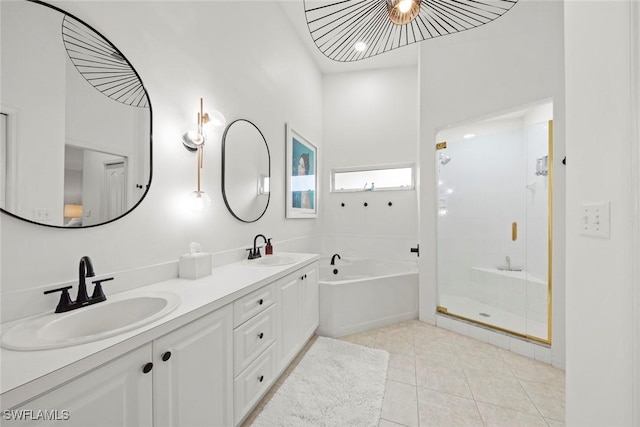 bathroom featuring tile patterned floors, a shower stall, a garden tub, and a sink