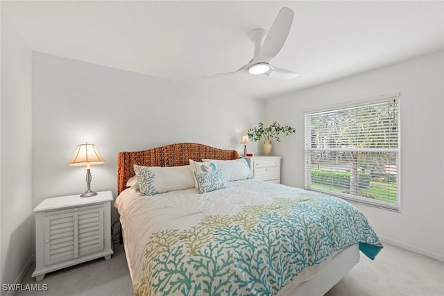 bedroom with ceiling fan, baseboards, and carpet floors