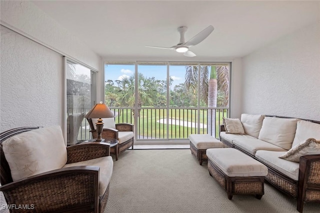 sunroom / solarium with a ceiling fan