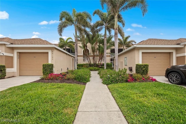 view of home's exterior featuring stucco siding, a lawn, a garage, and driveway