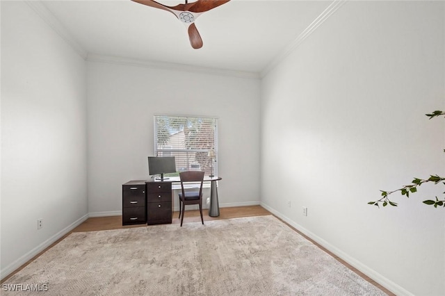 office area with baseboards, a ceiling fan, and crown molding