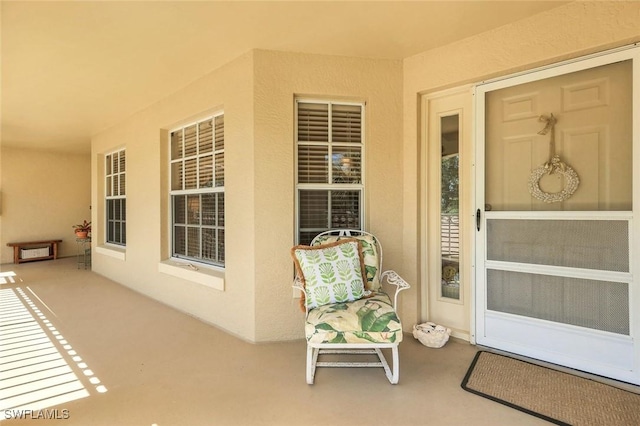 view of exterior entry featuring stucco siding