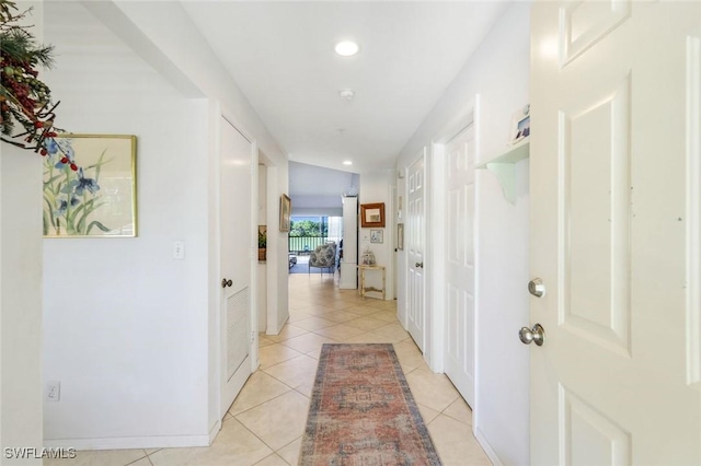 hallway with light tile patterned floors, recessed lighting, and baseboards