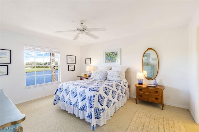 bedroom with a ceiling fan, baseboards, and carpet floors