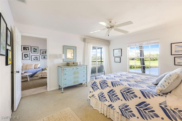 bedroom featuring access to outside, light colored carpet, and ceiling fan