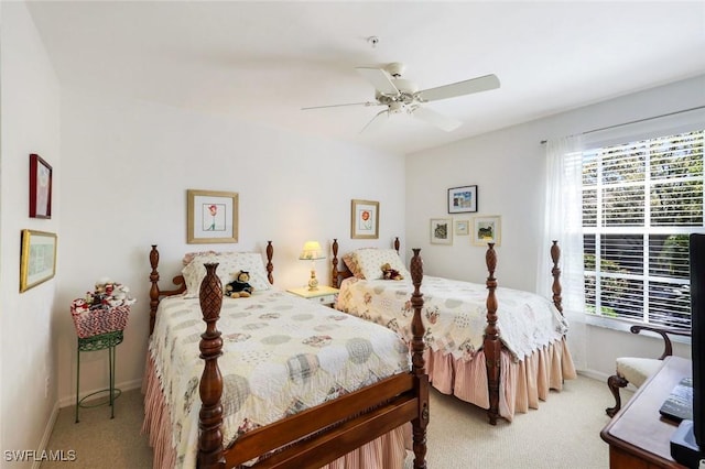 bedroom featuring ceiling fan, baseboards, and light carpet