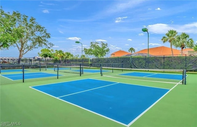 view of tennis court featuring fence