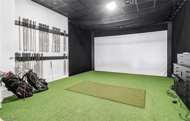 recreation room featuring golf simulator, carpet, and a paneled ceiling