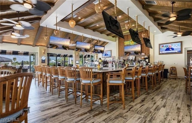 bar featuring beamed ceiling, wood ceiling, and ceiling fan