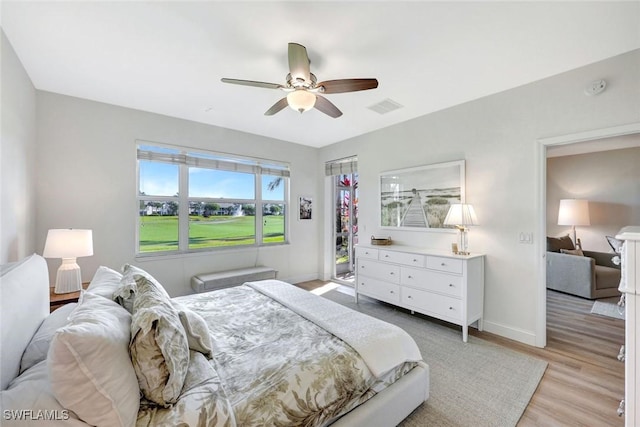 bedroom featuring a ceiling fan, light wood-style flooring, baseboards, and visible vents