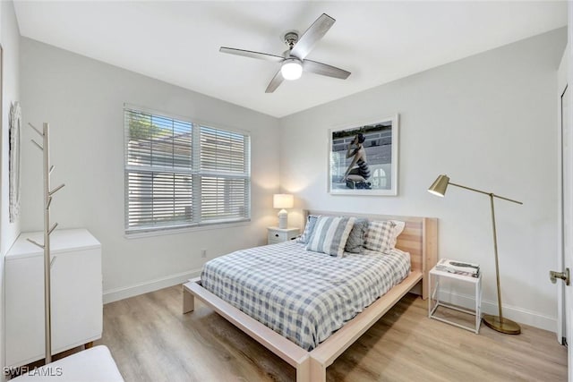 bedroom with baseboards, a ceiling fan, and light wood finished floors