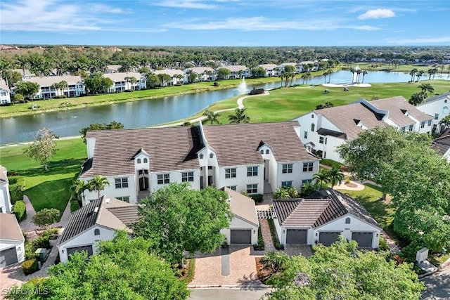 drone / aerial view featuring a residential view, golf course view, and a water view