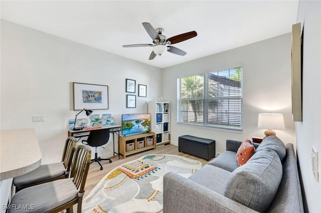 office space with light wood-style flooring, baseboards, and a ceiling fan